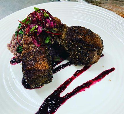 Chipotle-coffe rubbed lamb chops with cous cous and a blueberry balsamic gastric.