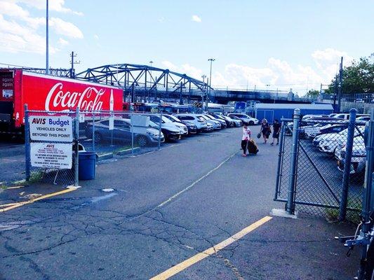 Avis and Budget car rental drop off, in empty lot to the right of the station.