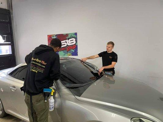 Our team tinting a windshield.