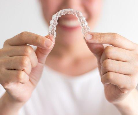 Clear aligners are a less invasive alternative for straightening teeth than metal braces