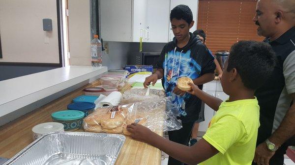 The boys make lunch for church members