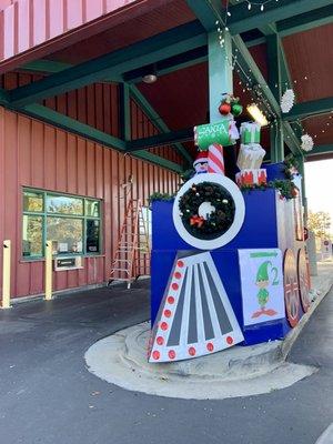 Holiday train and lights set up in the drive thru lanes at this post office