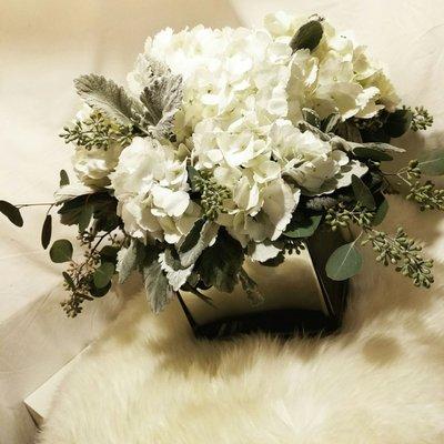 Lush centerpiece featuring this year's wedding trends: whites, greys, and neutral tones.