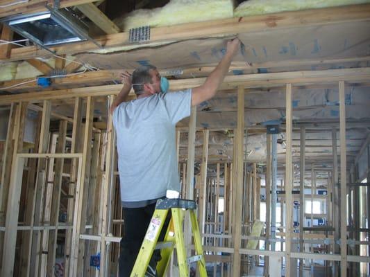 Installing Ceiling Insulation. Type Fiberglass batt with paper face