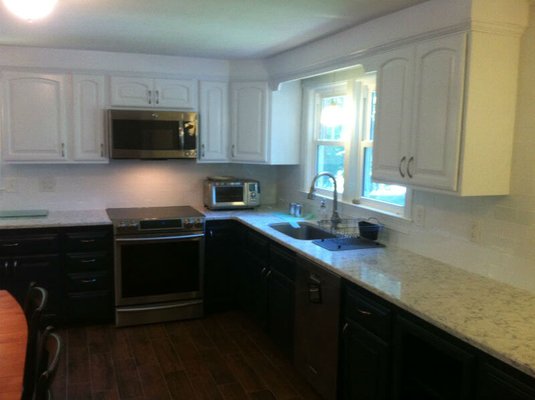 Black & white cabinetry work by Frankenstein Refinishing