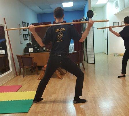 Qigong exercise with a staff