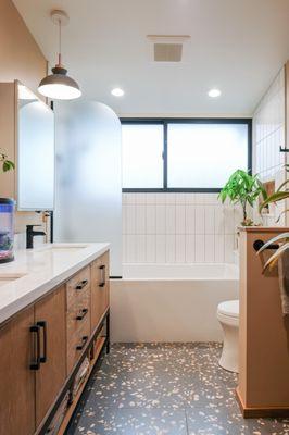 A bright and warm bathroom remodel. Terrazzo floor tiles, white oak vanity.