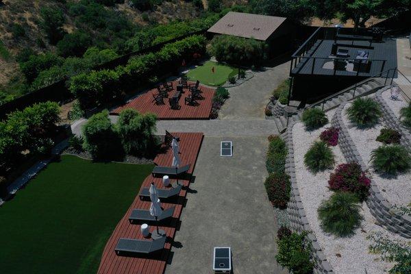 Navigate Stays presents: Aerial of our luxe retreat with BBQ and garden games.