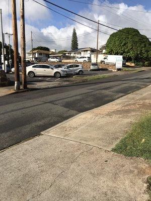 Parking lot is to the left (after the Bank of Hawaii parking lot)