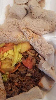 Awaze Tibs with local injera & cabbage and potatoes