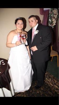 Cutting the cake next to the sweetheart table