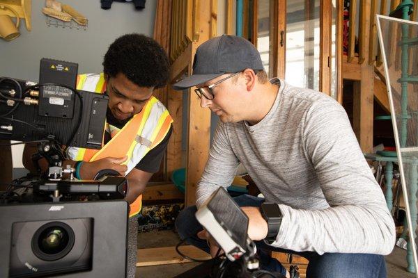 A couple of team members on set prepping the camera.