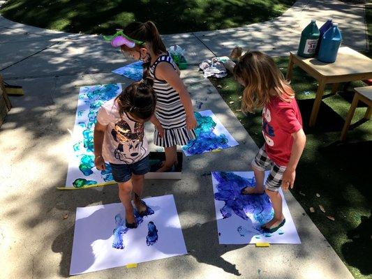 Barefoot painting and printing is a multi-sensory art and science experience as well an opportunity to share experiences with friends.