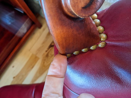 Finger tip points out the sharp edge jutting out from the left hand rest.  Poor craftsmanship/quality control on the Leopold chair.