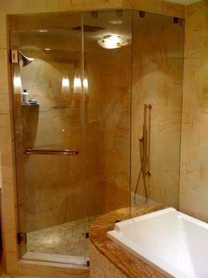 Frameless shower enclosure