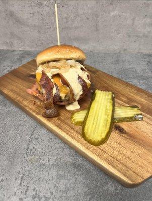 No. 1 Seller
 Cowboy Burger - 1/2lb Angus Beef, cheddar cheese, cowboy queso, bacon, grilled onions, tomatoes on a buttered Brioche Bun