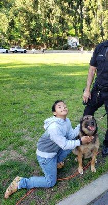 My grandson petting a K9 dog