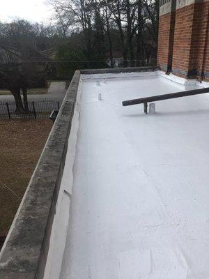 Liquid-applied silicone on TPO roof.