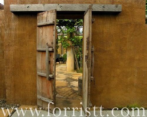 Custom stucco entrance with antique door.