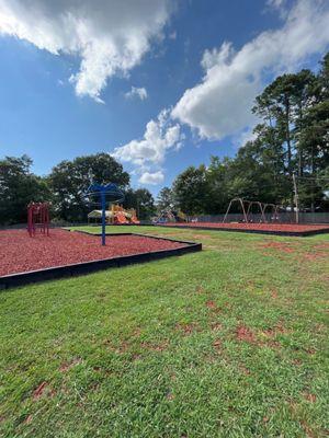 Monkey bars, swings, two play structures