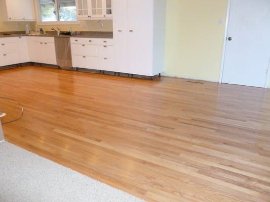 Refinished natural oak hardwood.