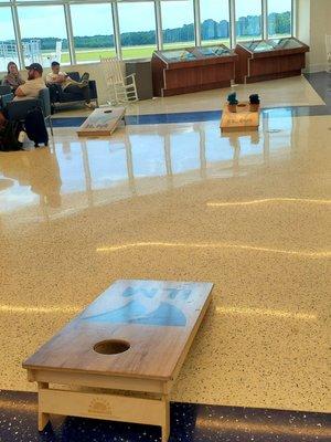 I mean, OF COURSE there's cornhole in the middle of the "busiest" (only) terminal in ILM