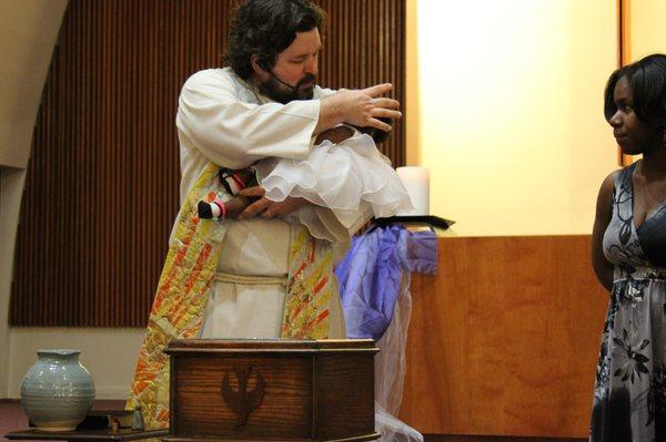 Pastor Clay baptizing an infant