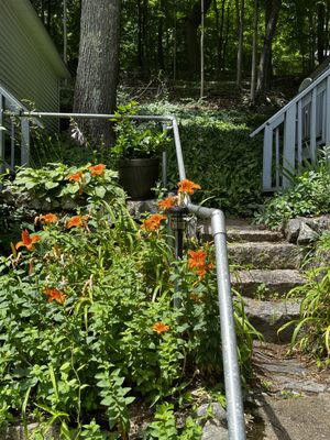 Gorgeous rustic stairs surrounded by beautiful landscaping and with strong handrails for those of us needing extra support.