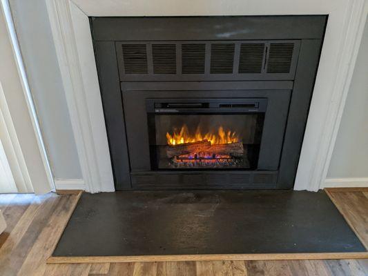 The new popular fireplace modification, electric insert with custom surround