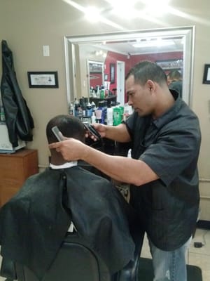 Omar working on a fade haircut