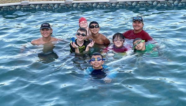 Carol and Colby teaching group swim classes