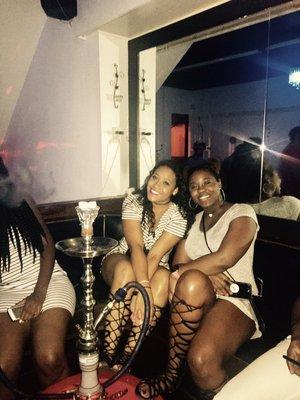 Pretty ladies enjoying a night out, smoking a scrumptious hookah!