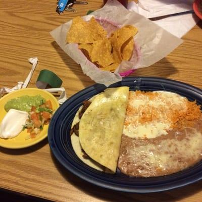 Quesadilla with rice and beans covered in cheese sauce