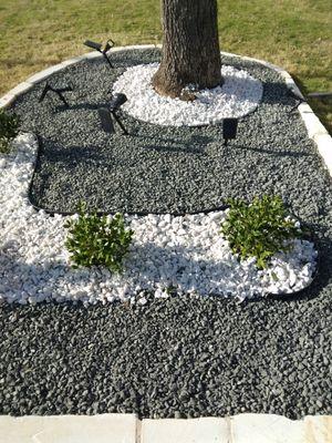 Flower bed black start gravel and crushed marble and White limestone boulder