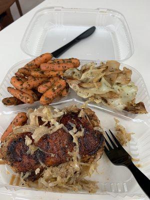 Blackened pork chop with a side of cabbage and carrots