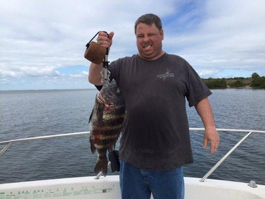 Doug Tresslor holds his 23 inch sheepshead