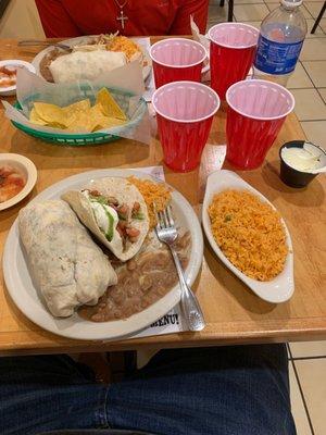 Carne asada burrito, Chicken Taco, Mexican Rice, Refried Beans