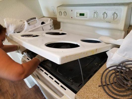 In the process of getting under the stove top where food tends to drop.