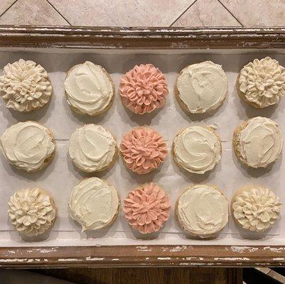 Sugar cookies for a wedding! White ones are frosted with an almond buttercream and the pink are strawberry.