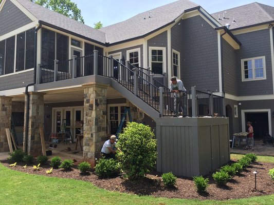 Composite trex deck with sunroom addition.