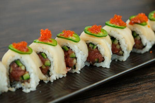 Unleash your wild side with our Tiger Eye roll!  A fusion of flavors--creamy crab, spicy tuna, and a hint of tangy sauce.