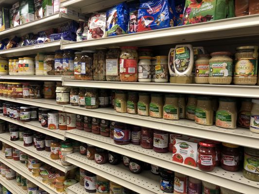 A nice variety of pickled jars and other condiments.