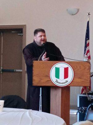 Father giving opening remarks at St. Joseph's Table.