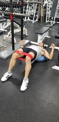 Wes doing a unique functional bridge on the BOSU ball with a resistance band!! Glute burn!!