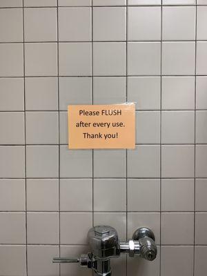 This sign was above the urinal.