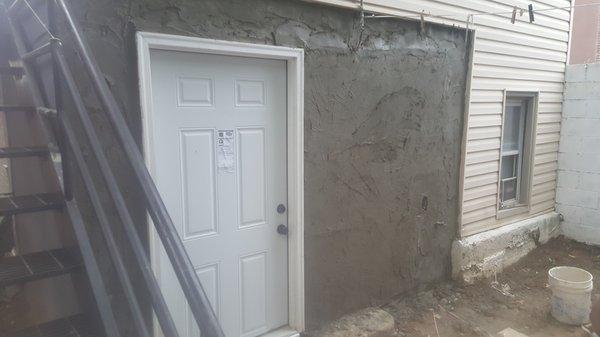 First layer of stucco , with wire mesh.