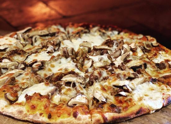 Fungi Pizza, house ground sausage, house made mozzarella cheese and wood fired in our pizza oven