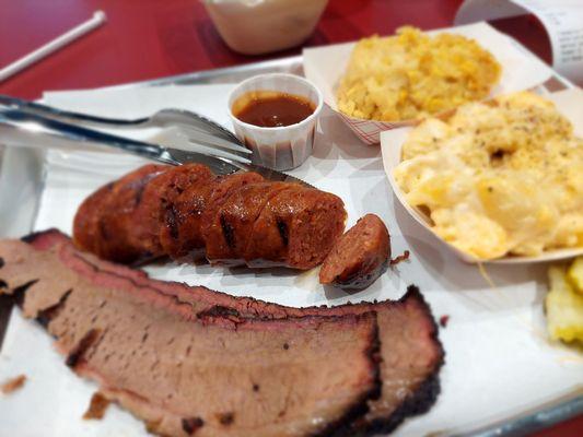 Sliced brisket, hot sausage, corn pudding, and Mac 'n cheese