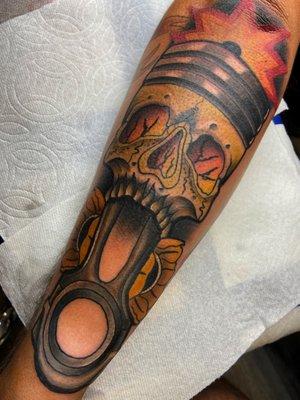 Neotraditional skull piston tattoo