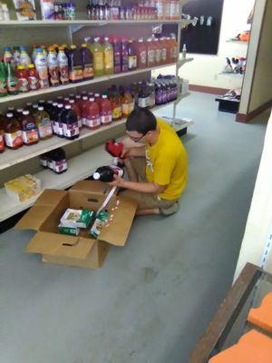 Austin Dabbs learning to stock on his first day.